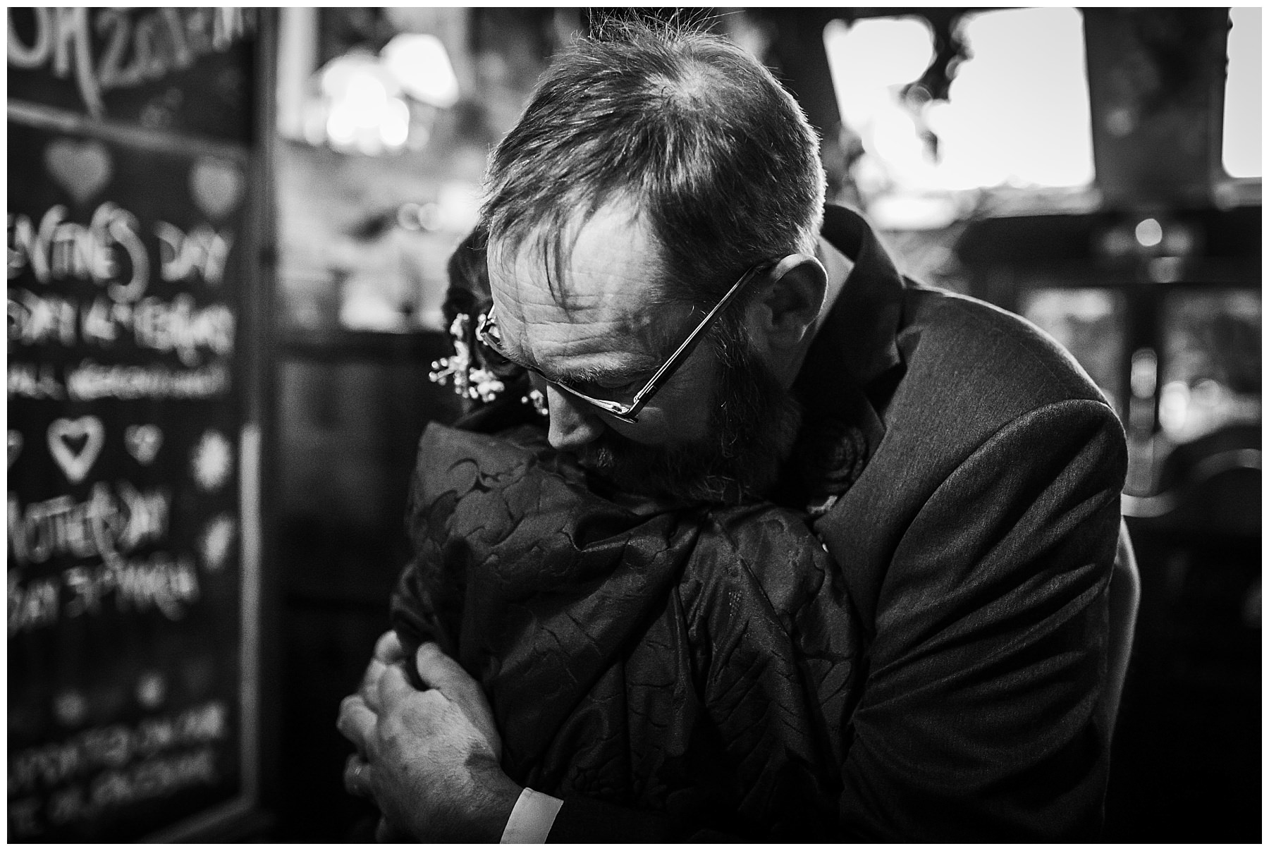 Bride and father embrace before wedding ceremony