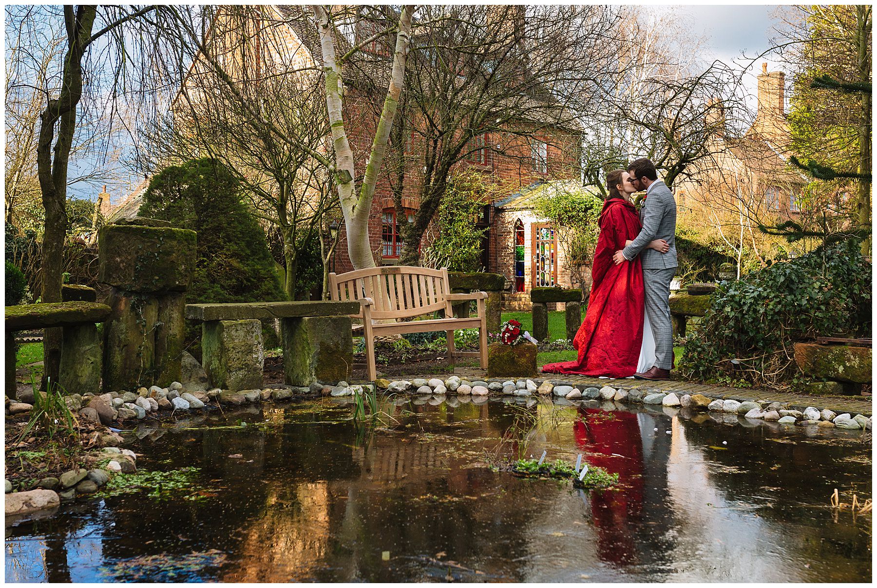 couple stand on the edge of a frozen pond at the hundred house hotel