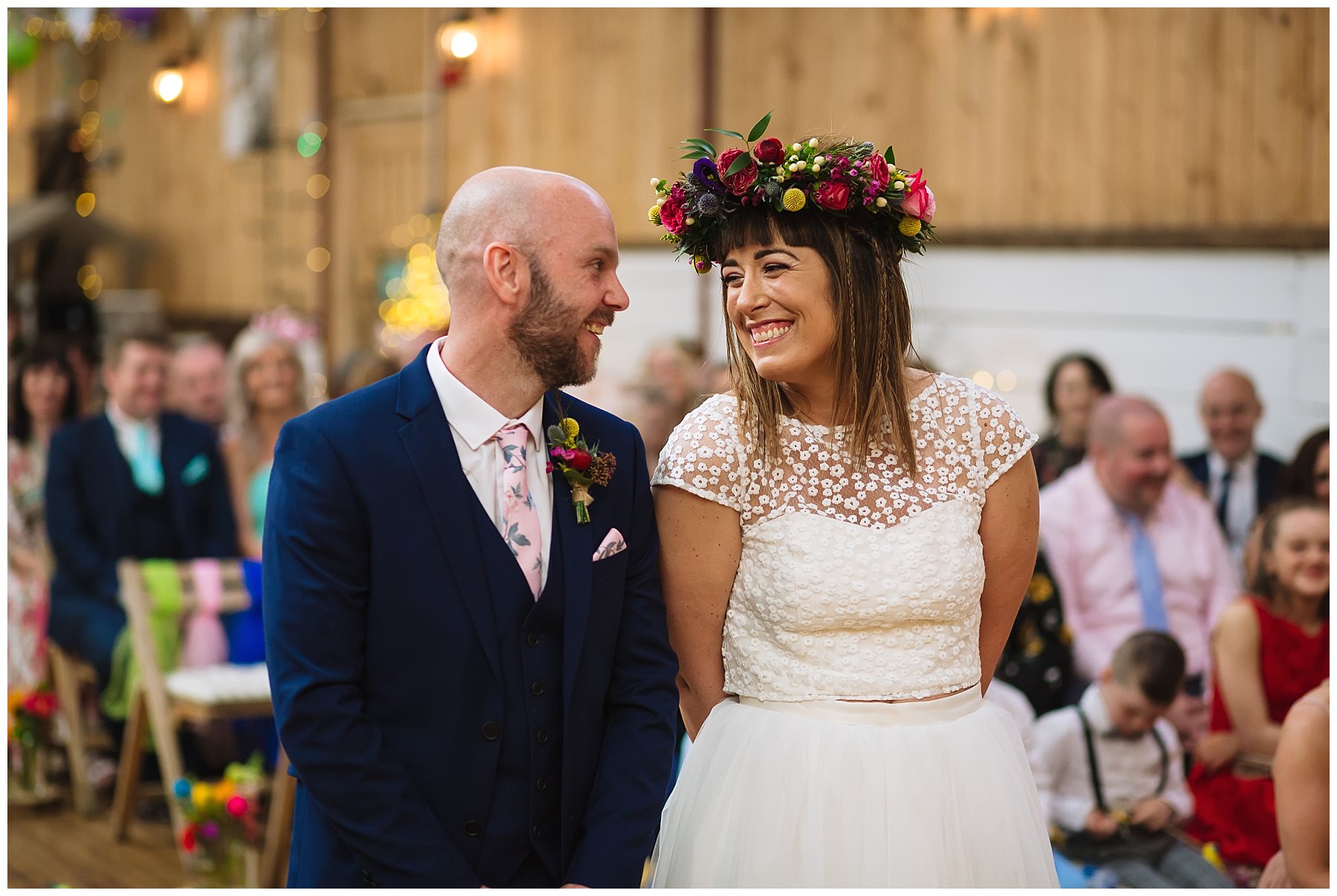 bride and groom smile at each other during quirky wedding at the wellbeing farm