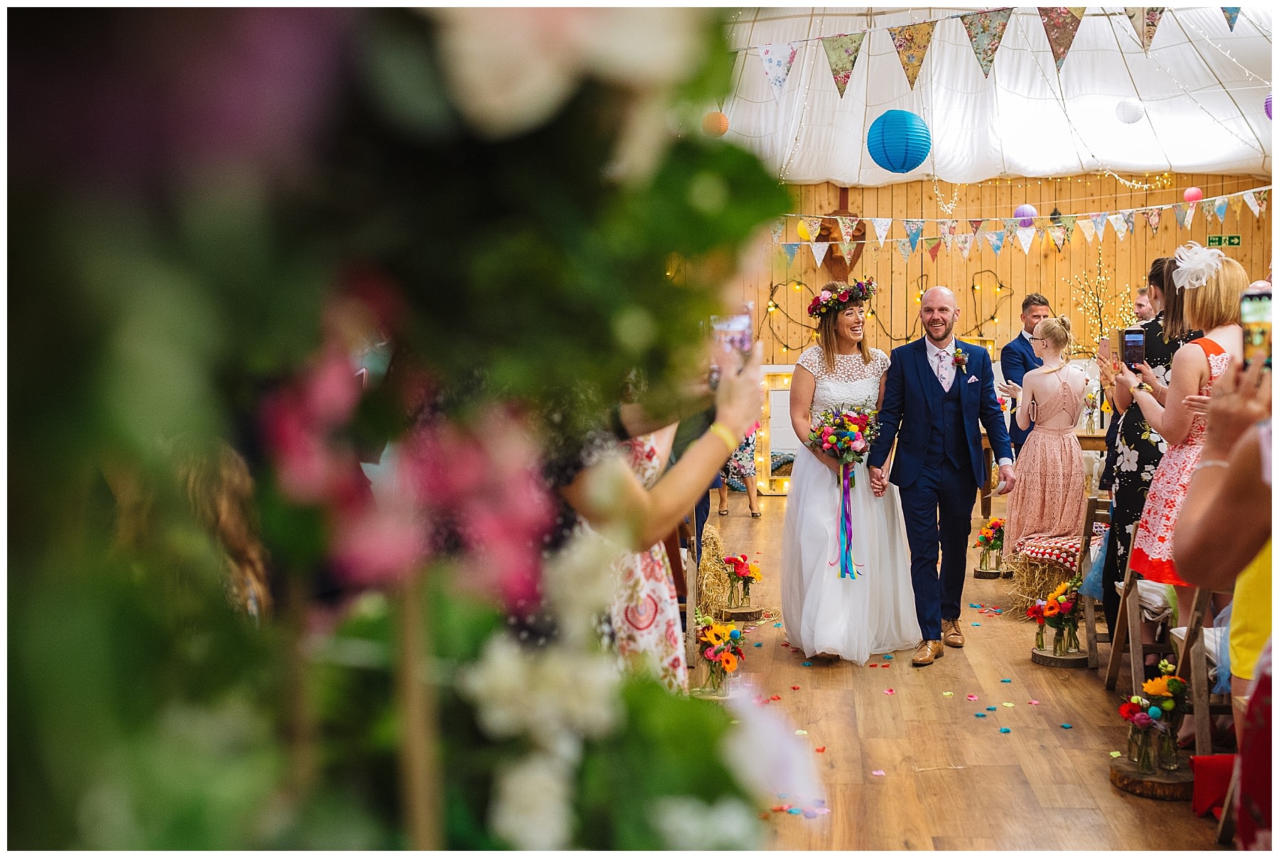 bride and groom walk down the isle as husband and wife at the wellbeing farm