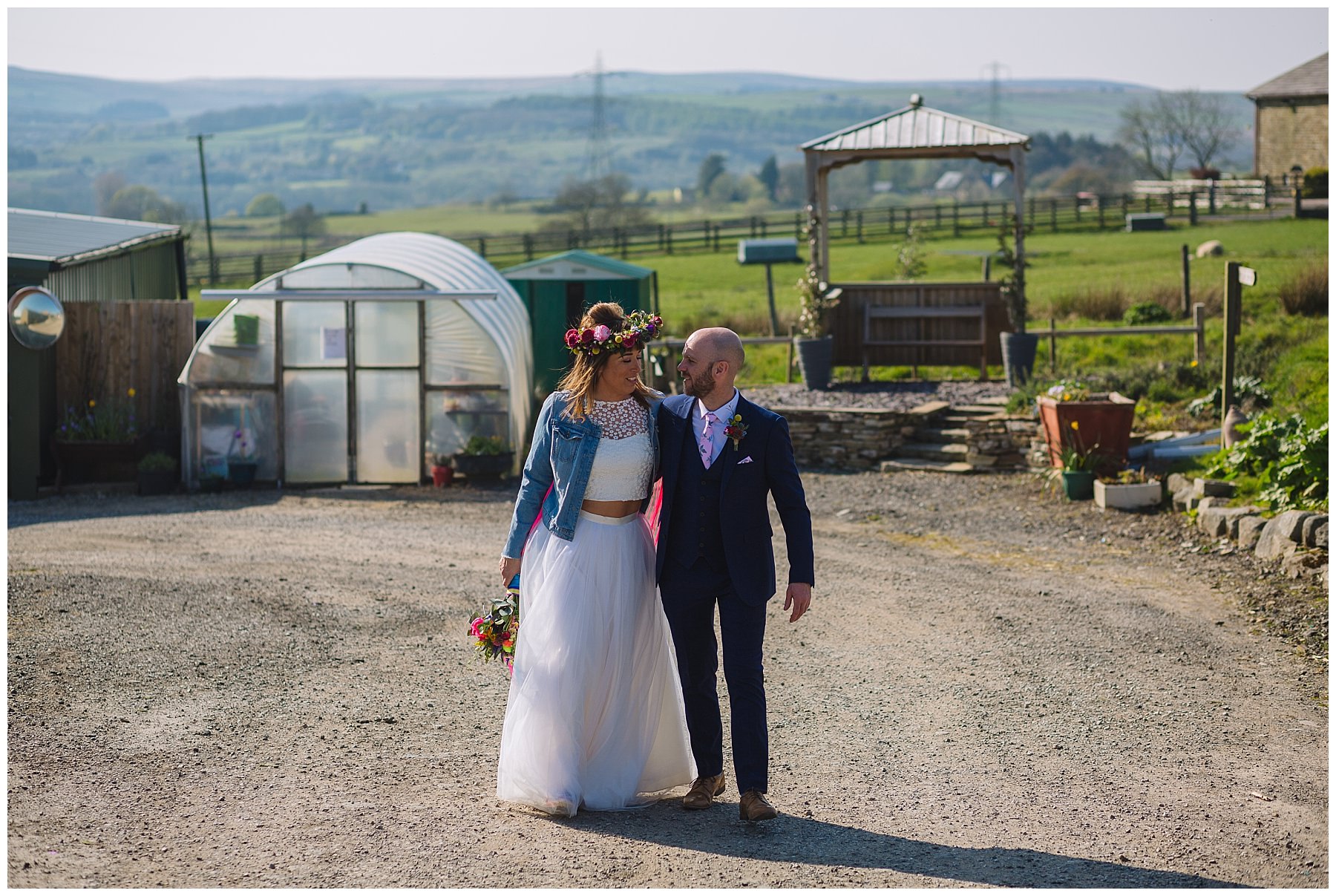 Bride and groom wander through the grounds of the wellbeing farm