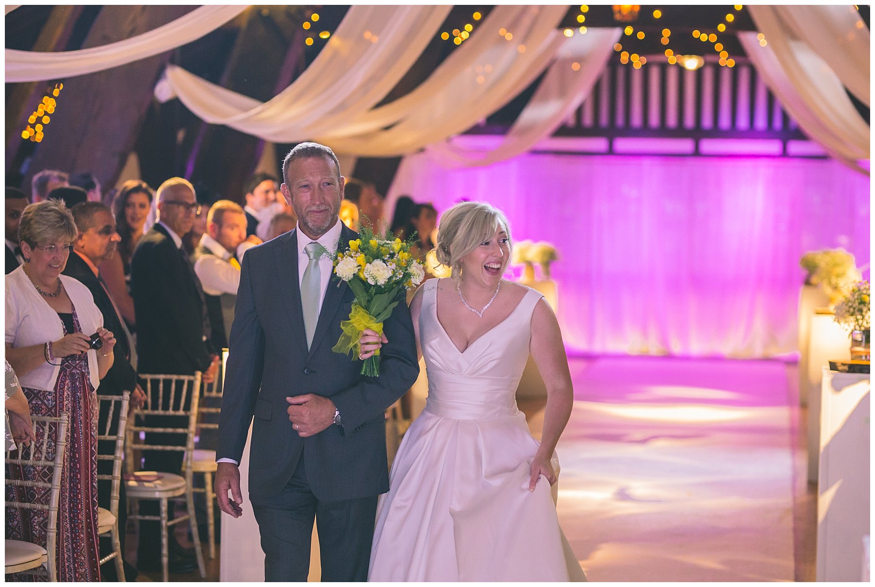 Bride and father walk down the isle at rivington barn