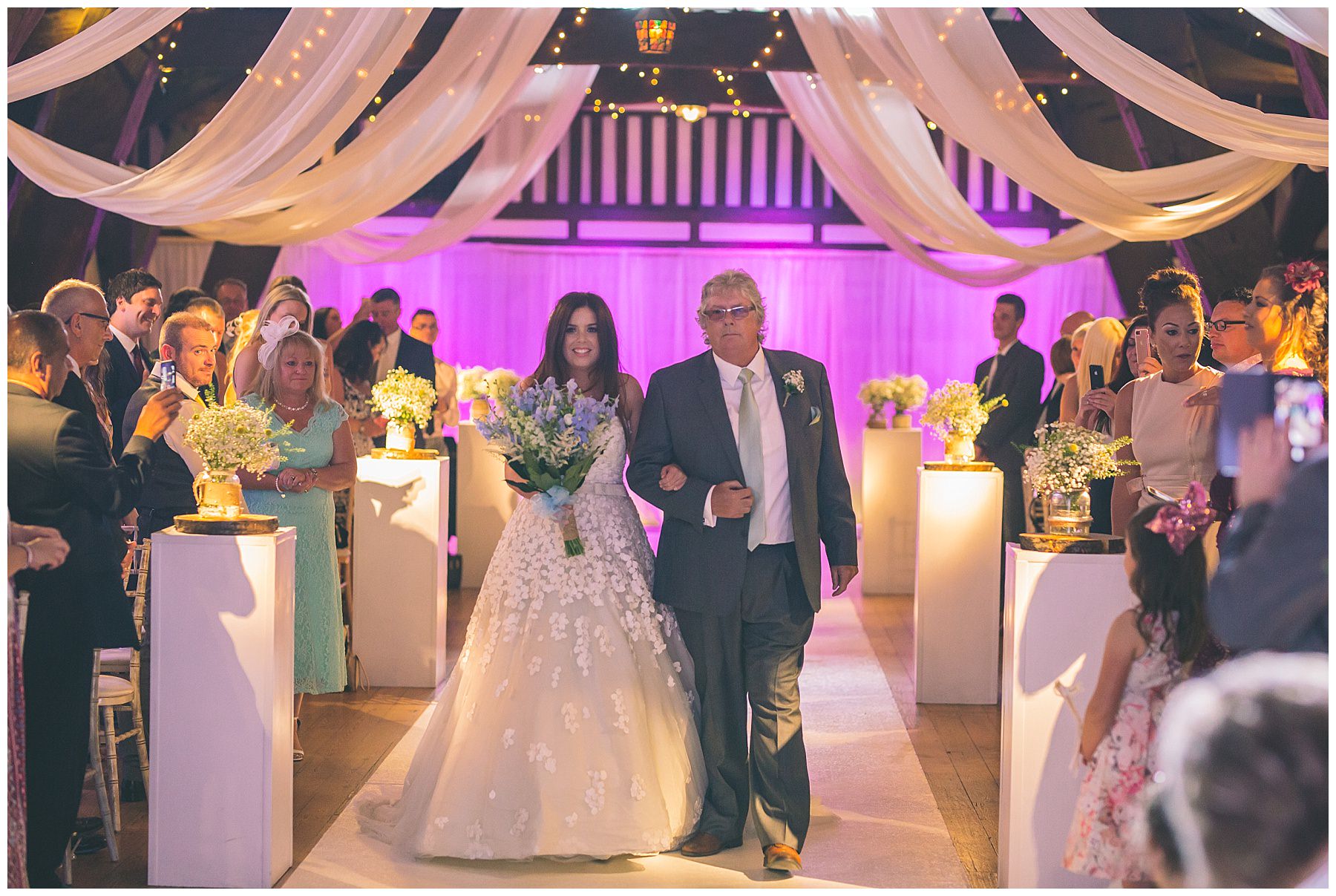 Bride walks down the isle with dad at rivington barn wedding