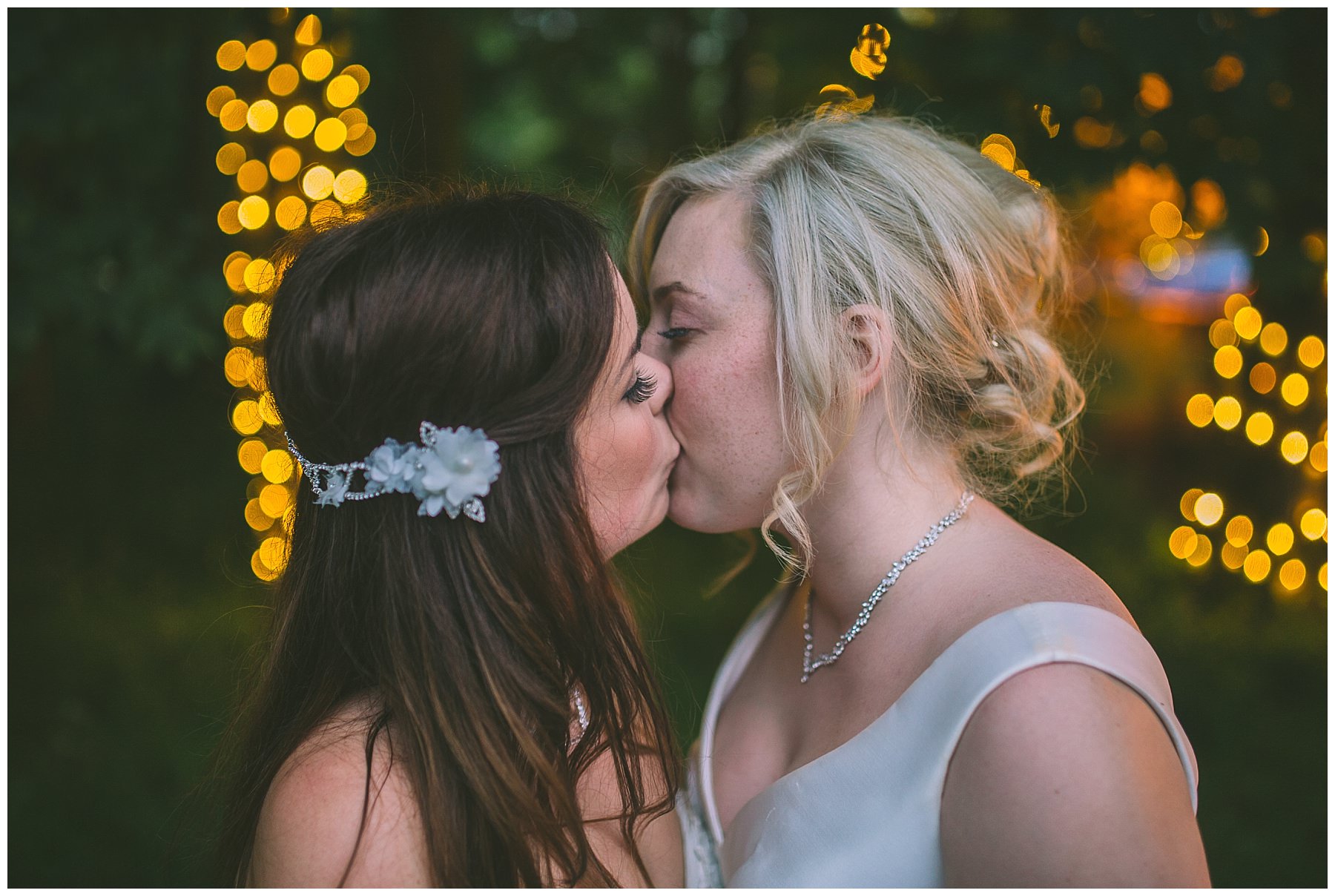 Two brides kiss at twighlight at rivington barn