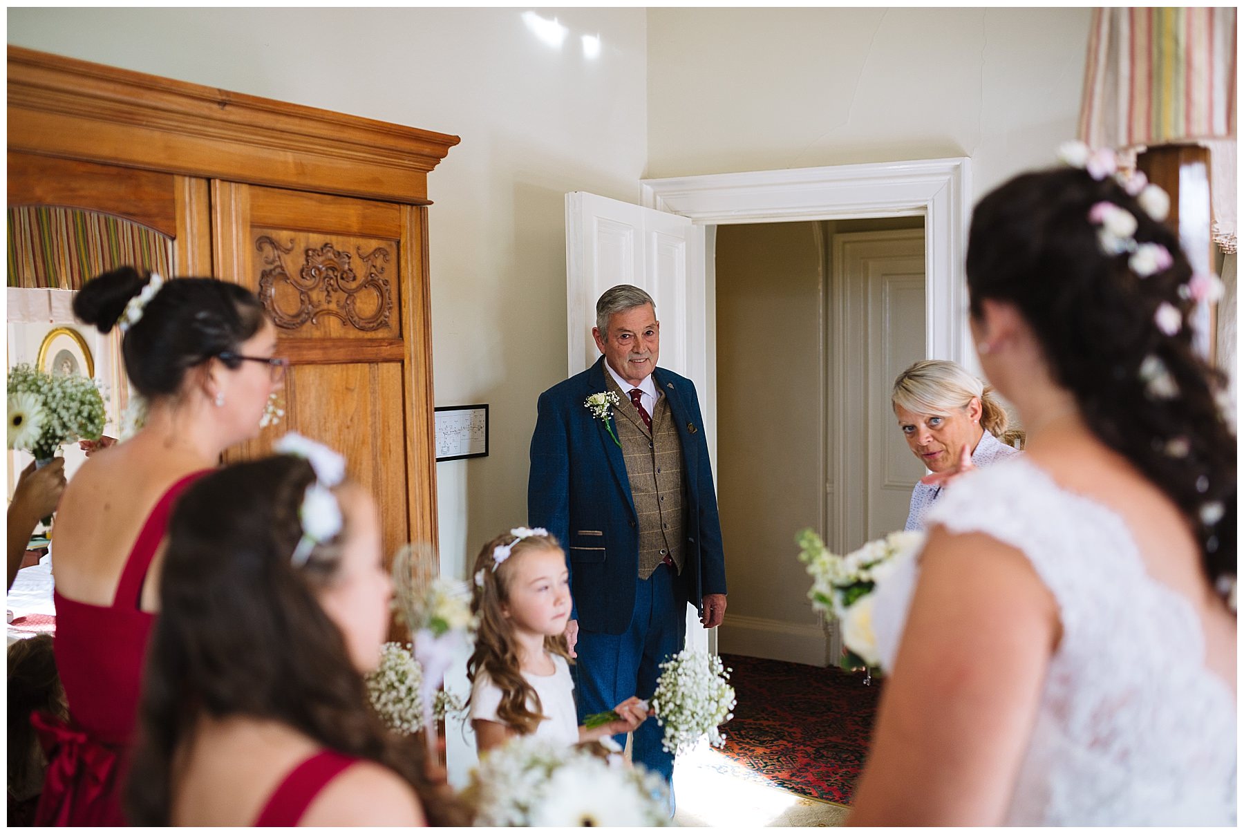 father of the bride looks to daughter during bridal prep