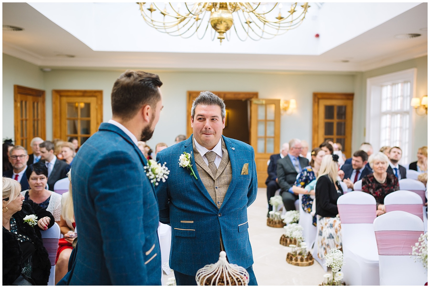 groom waits nervously for his bride at willington hall wedding venue