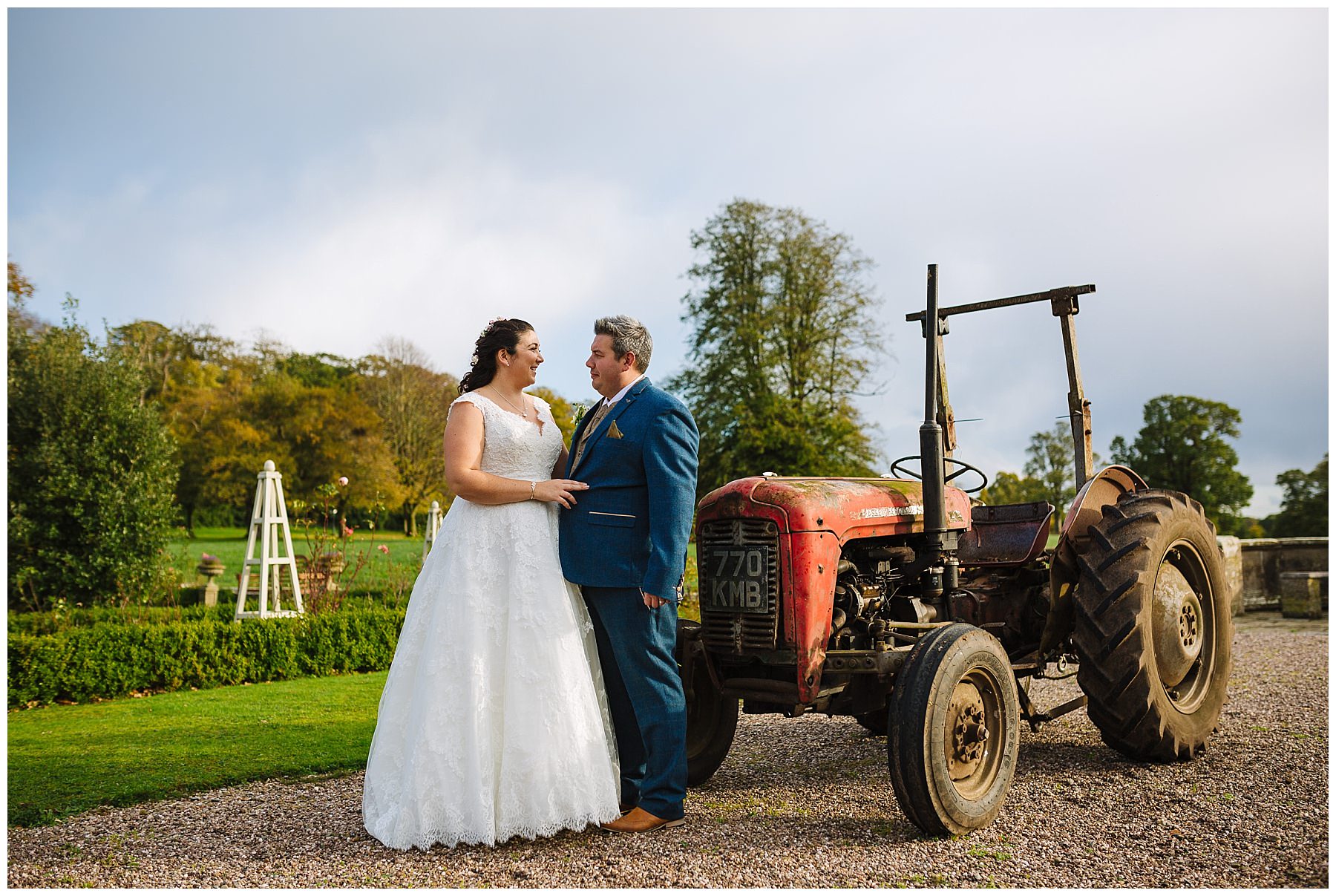 bride and groom stand by tractor at willington hall