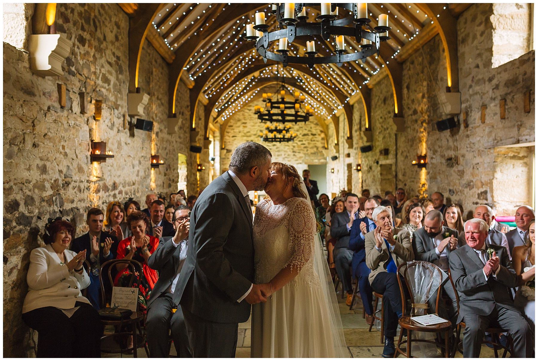 bride and grooms first kiss at the stunning healey barn