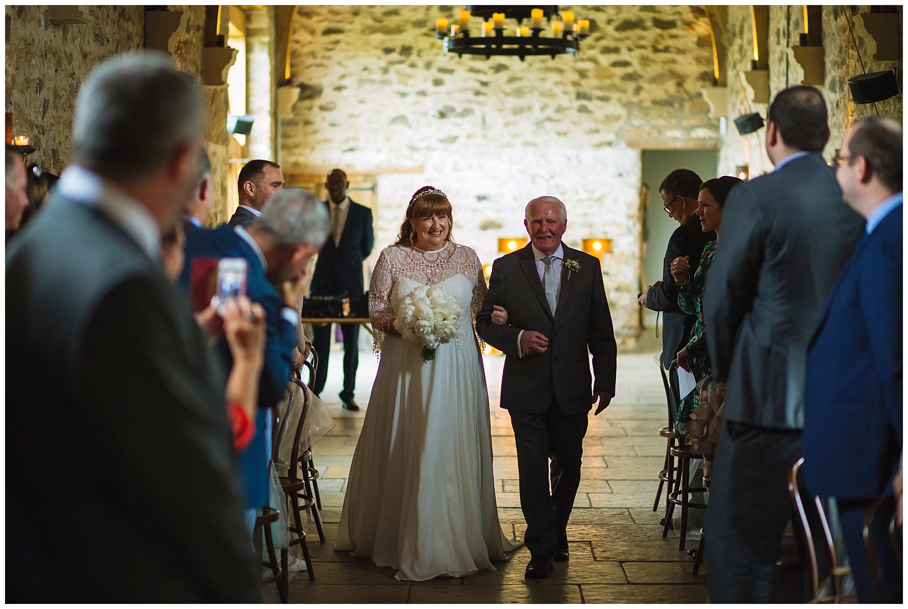 bride and father arrive for healey barn wedding ceremony