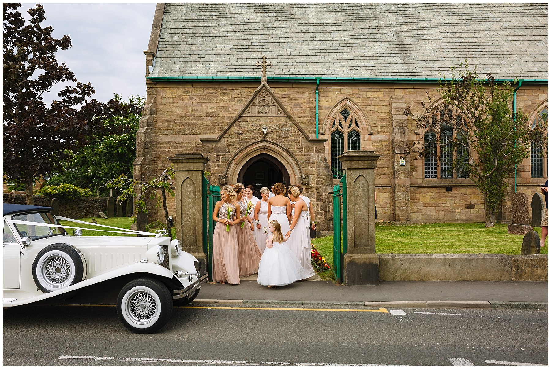 Bridesmaids wait outside church as the bridal car arrives