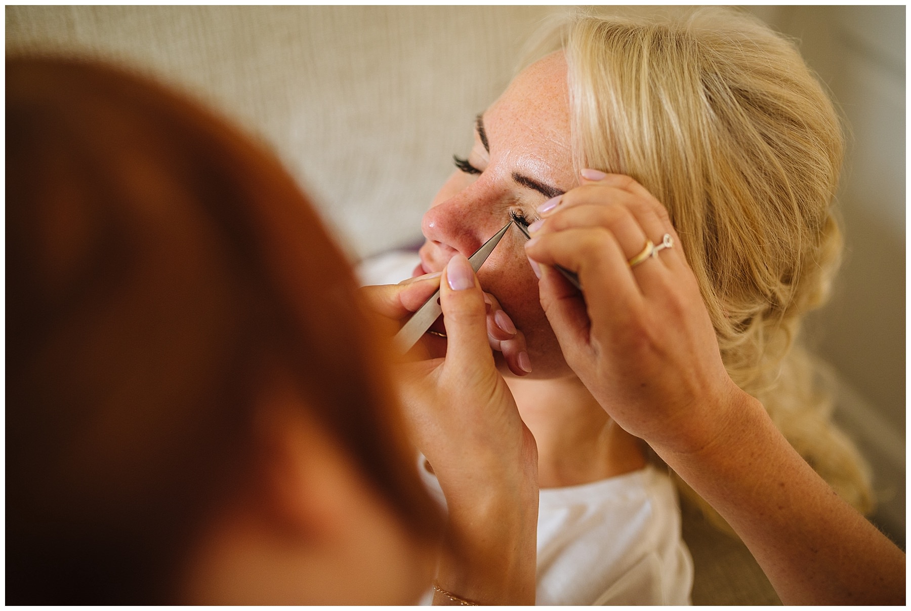 Bride has eyelashes applied