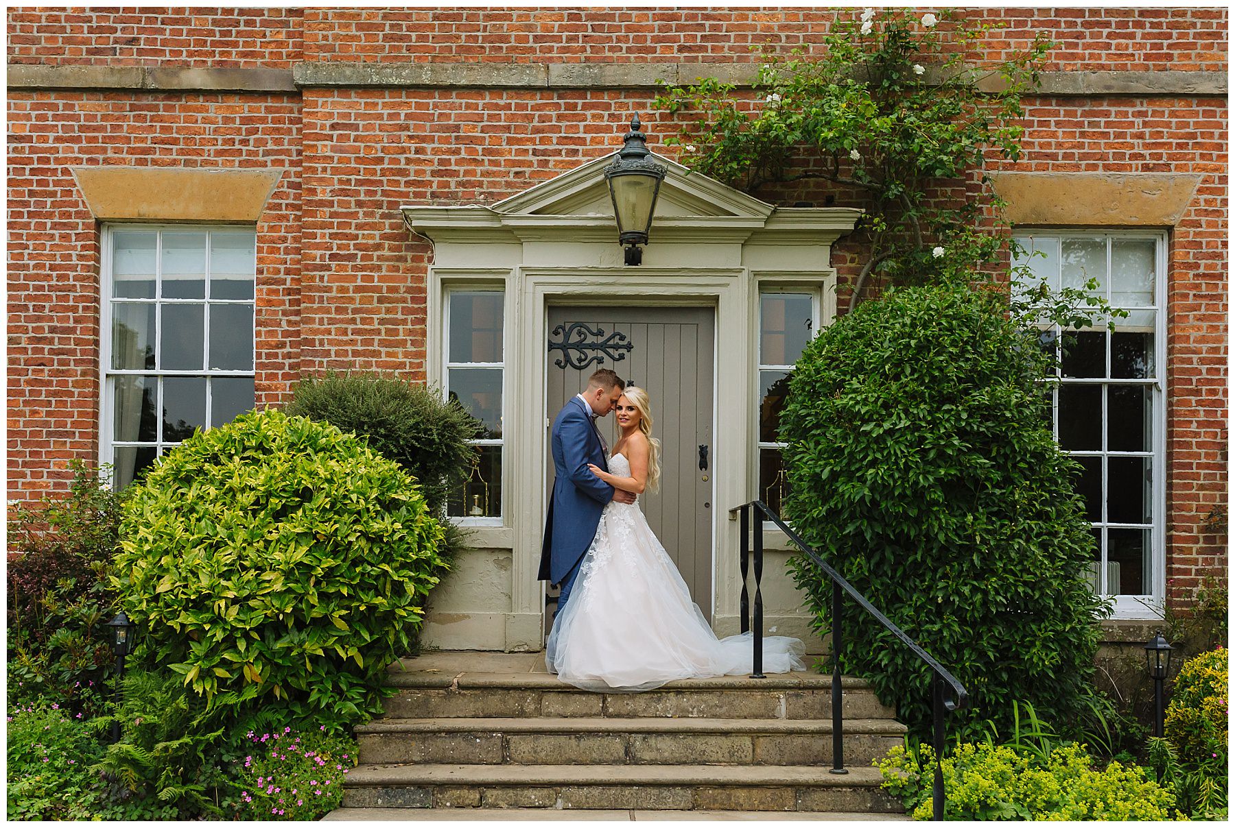 Beautiful bride and groom in front of the house at rivington barn