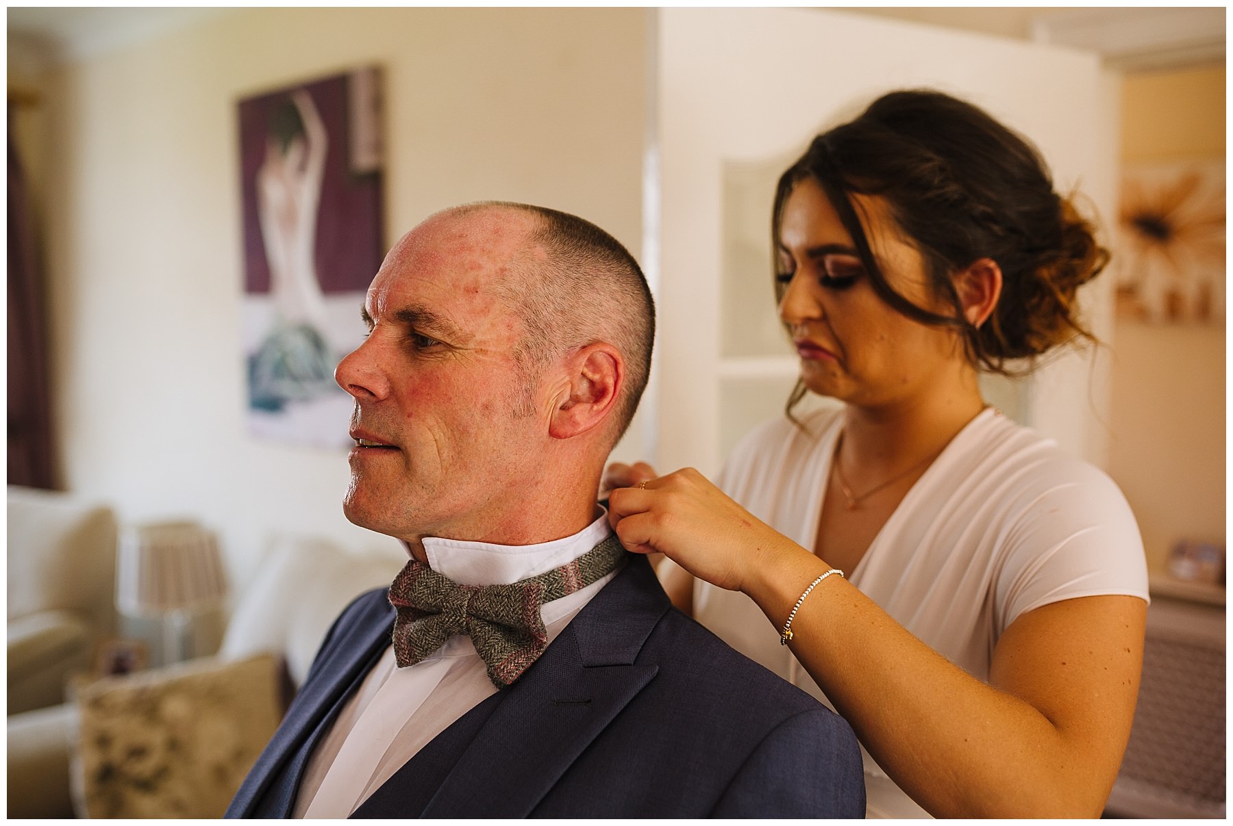 father of the bride has bow tie fastened