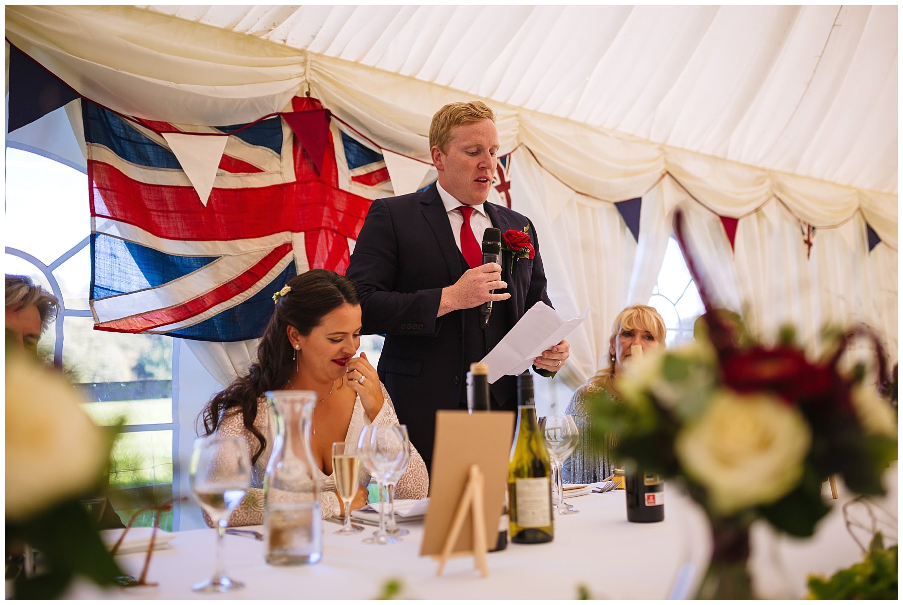 groom stands to address his guests at Hilltop House wedding