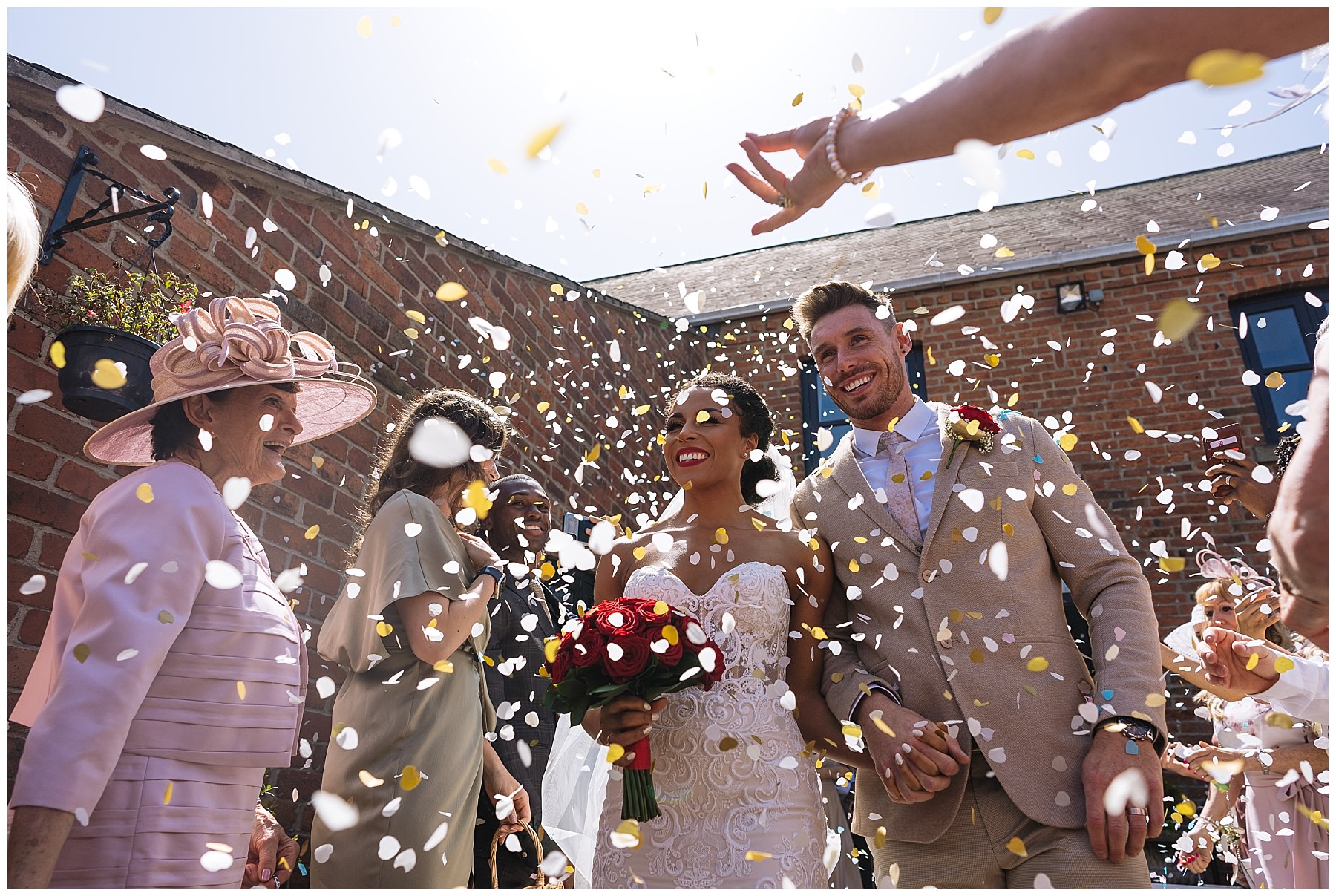 confetti thrown over bride and groom at swancar farm
