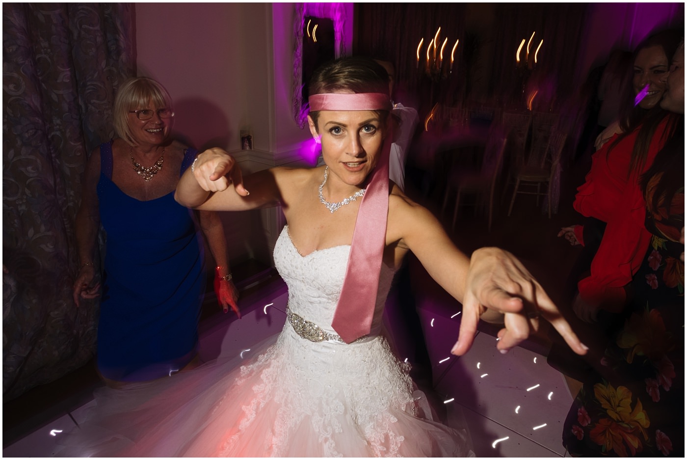 Bride on the dance floor at Eaves hall with Tie around head