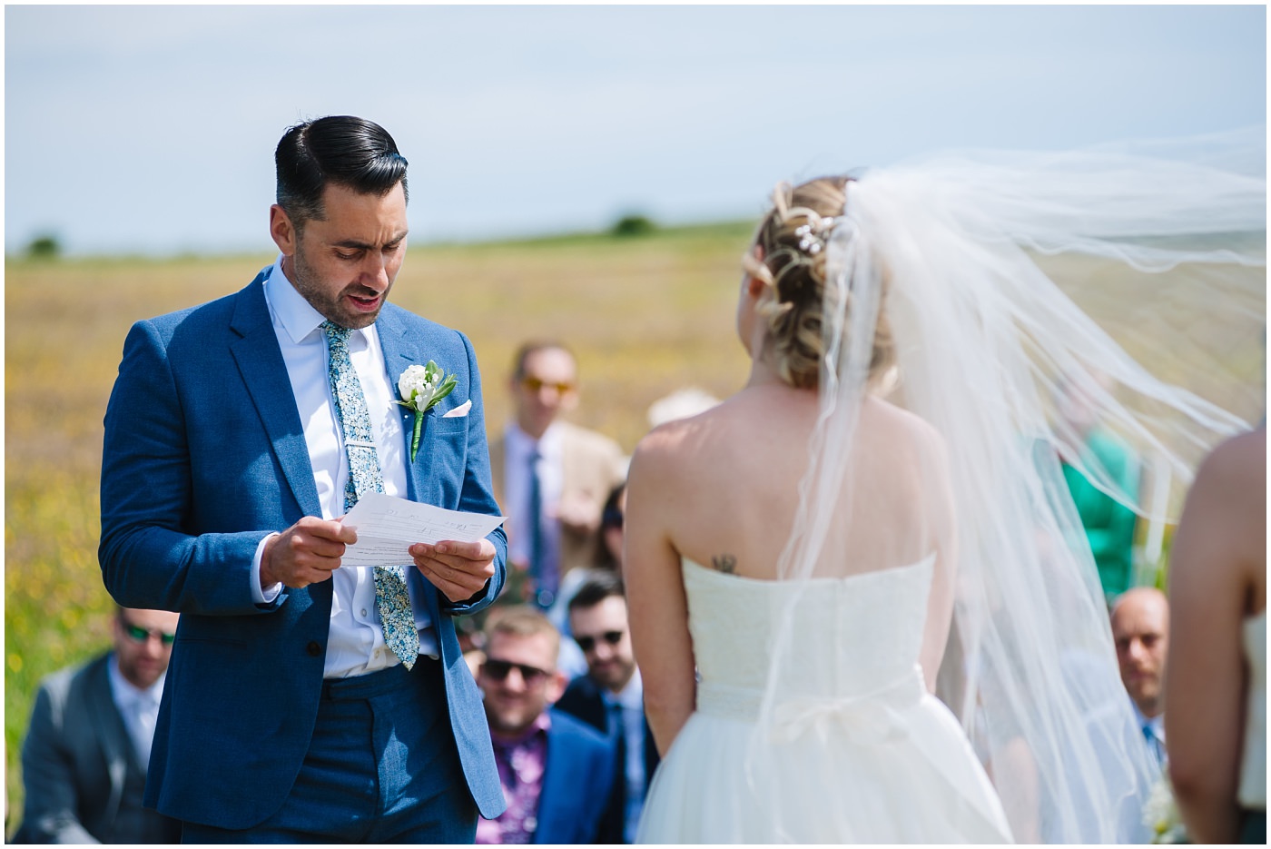 groom reads his vows in outdoor wedding ceremony at wildwood and eden