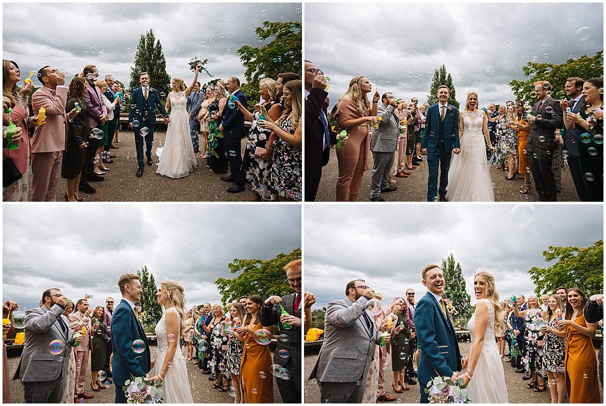 bride and groom exit wedding ceremony through bubbles