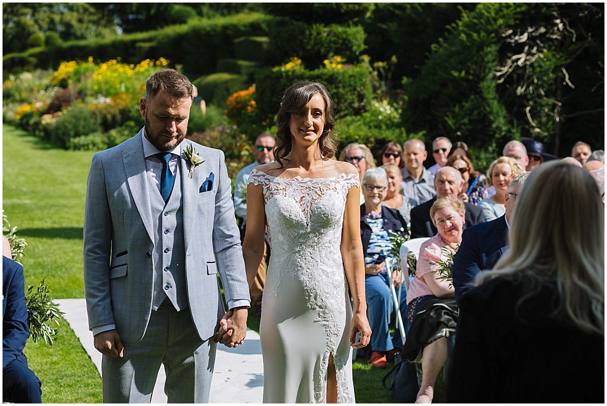 wedding ceremony in the gardens at arley hall in cheshire