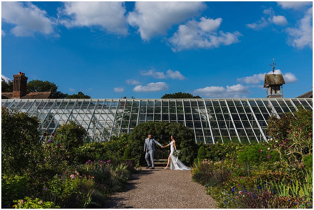 wedding couple take a stroll through arley hall gardens
