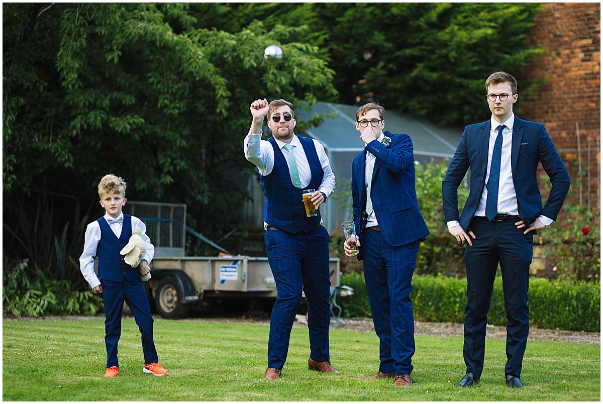 groomsmen and wedding guests play garden games at cheshire wedding