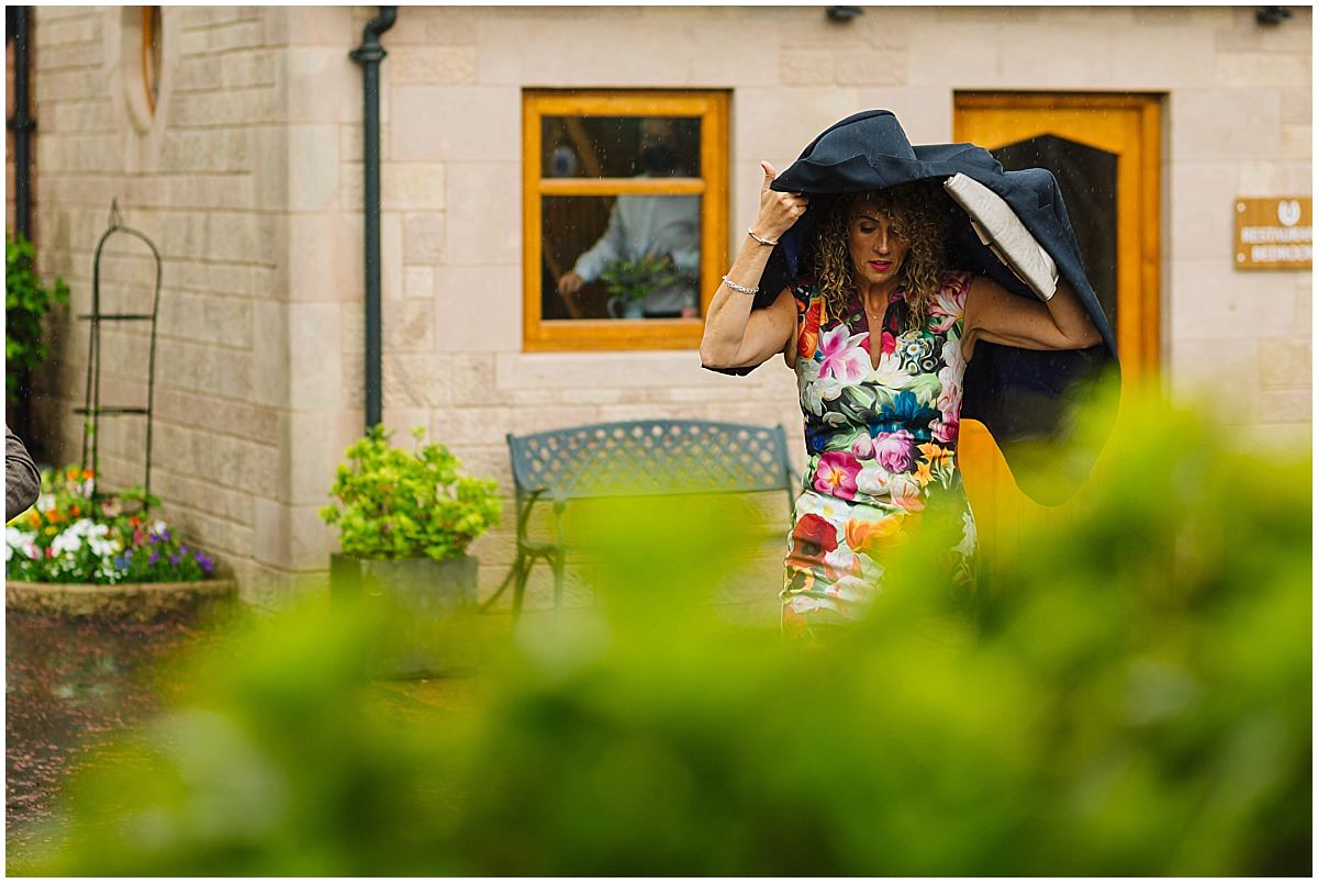 guests arrive for rainy wedding at heaton house farm