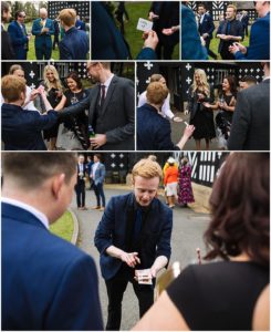 A collage of images showing a magician performing card tricks for a group of elegantly dressed people at an outdoor event. The magician, holding cards and engaging with the guests, is featured in each of the five pictures, with onlookers expressing surprise and amusement.