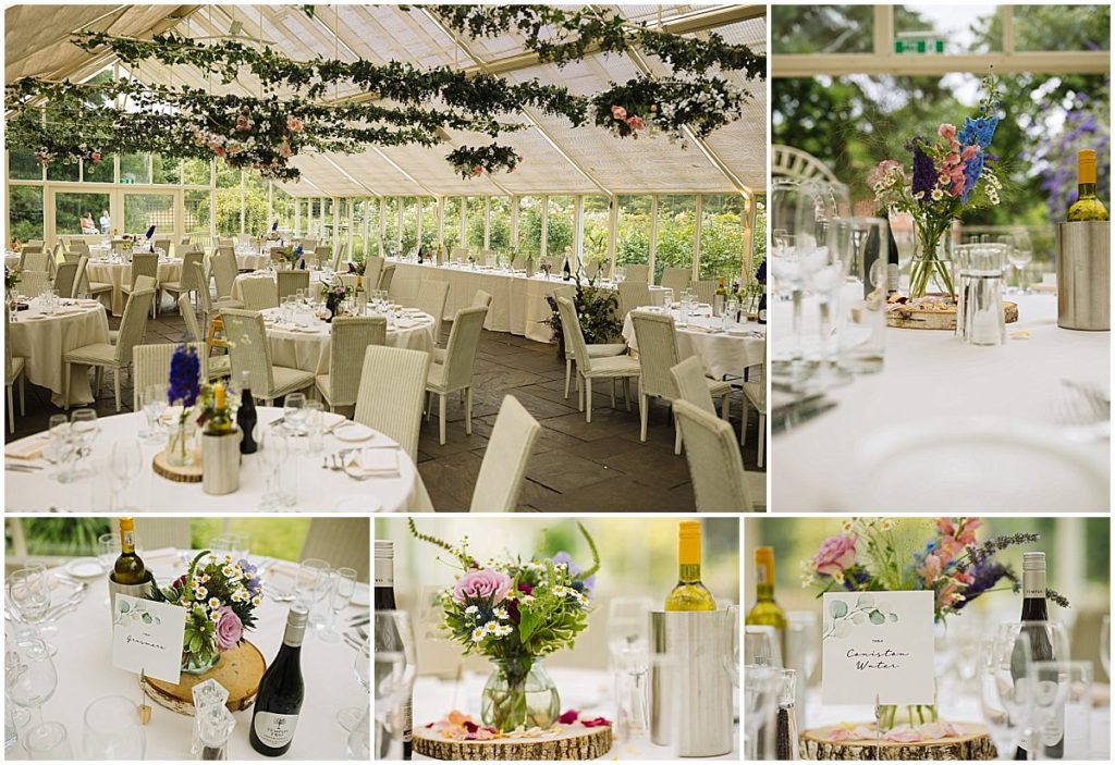 A beautifully arranged dining area with white tables and chairs, adorned with flowers and greenery, set for a formal gathering in a bright glass-enclosed space at abbeywood estate.